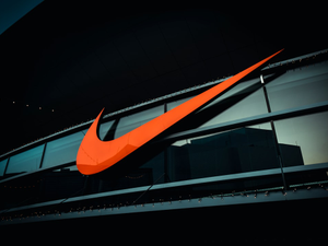 a large orange nike logo on the side of a building