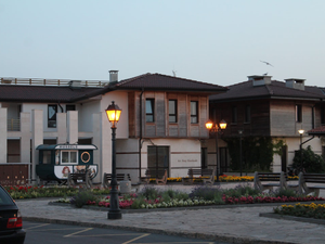 A car is parked in front of a row of houses
