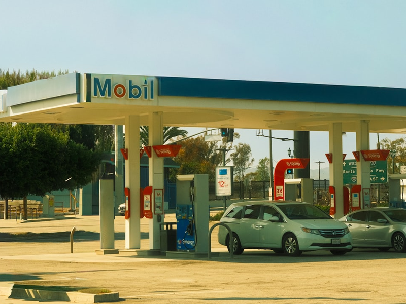 Mobil gas station with cars at pumps