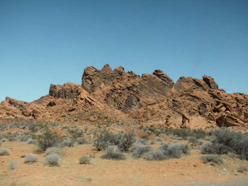 A large rock formation in the middle of a desert