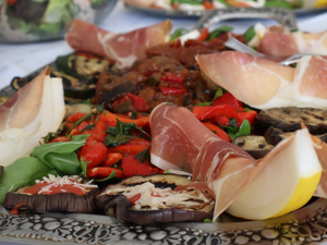 A platter of meats and vegetables on a table