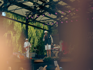 Male singer on stage with mic.