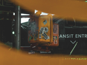 a yellow traffic light sitting on the side of a road