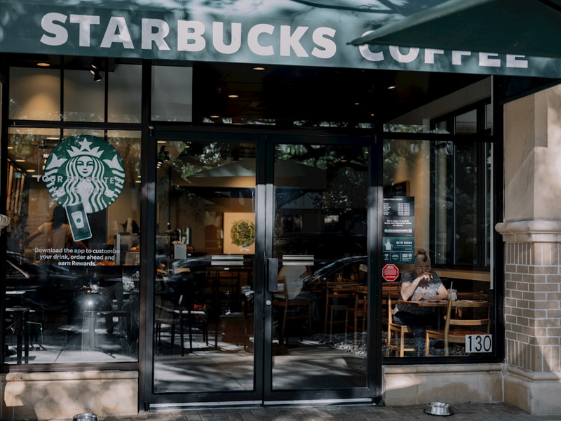 a starbucks coffee shop with a person sitting at a table
