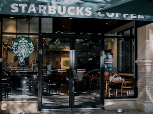 a starbucks coffee shop with a person sitting at a table