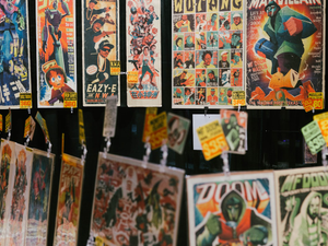 a bunch of posters hanging on a wall
