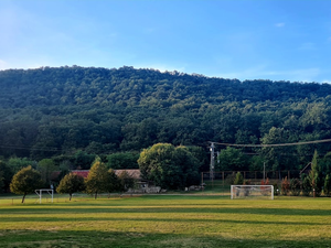 a soccer field in front of a mountain