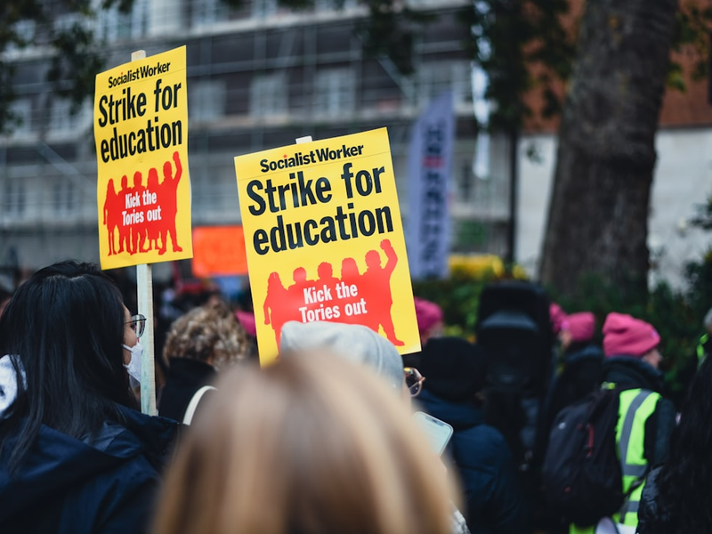 a group of people holding up yellow signs