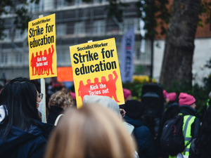 a group of people holding up yellow signs