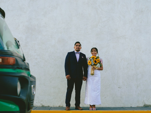 man in black suit standing beside woman in white wedding dress