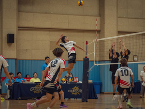 A group of people playing a game of volleyball