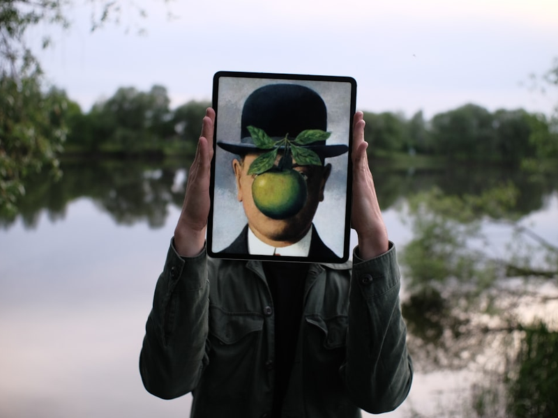 person holding black tablet computer with green fruit