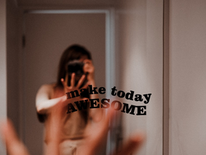 a person taking a picture of themselves in a mirror