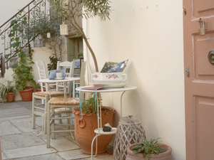 A cozy patio area with tables and plants.