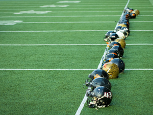 A line of football players lined up on the field