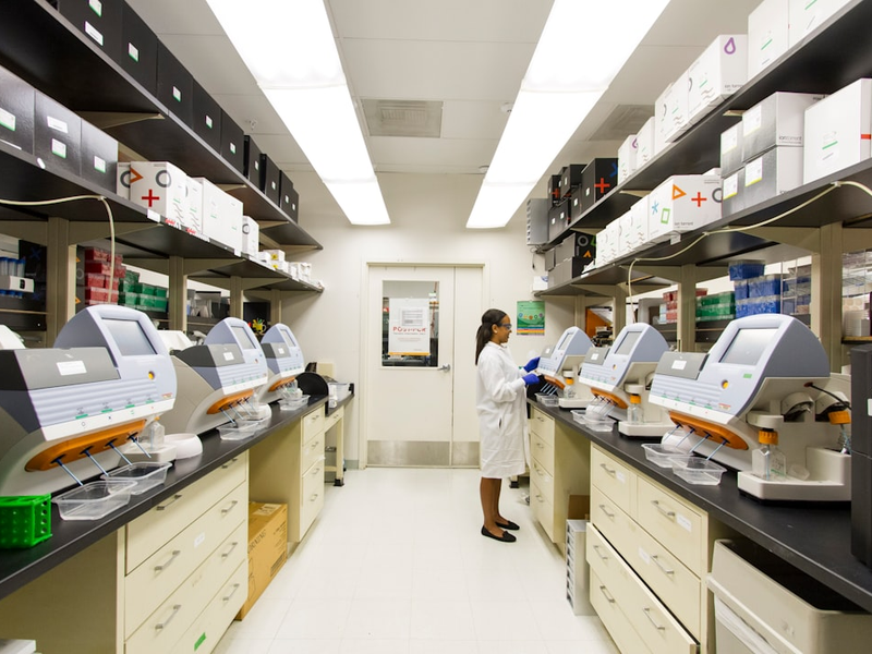 DNA Genotyping and Sequencing. A technician works among a fleet of desktop genomic sequencing machines at the Cancer Genomics Research Laboratory, part of the National Cancer Institute's Division of Cancer Epidemiology and Genetics (DCEG). Creator: Daniel Sone