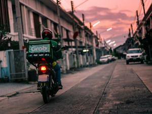 a person riding a motorcycle down a street