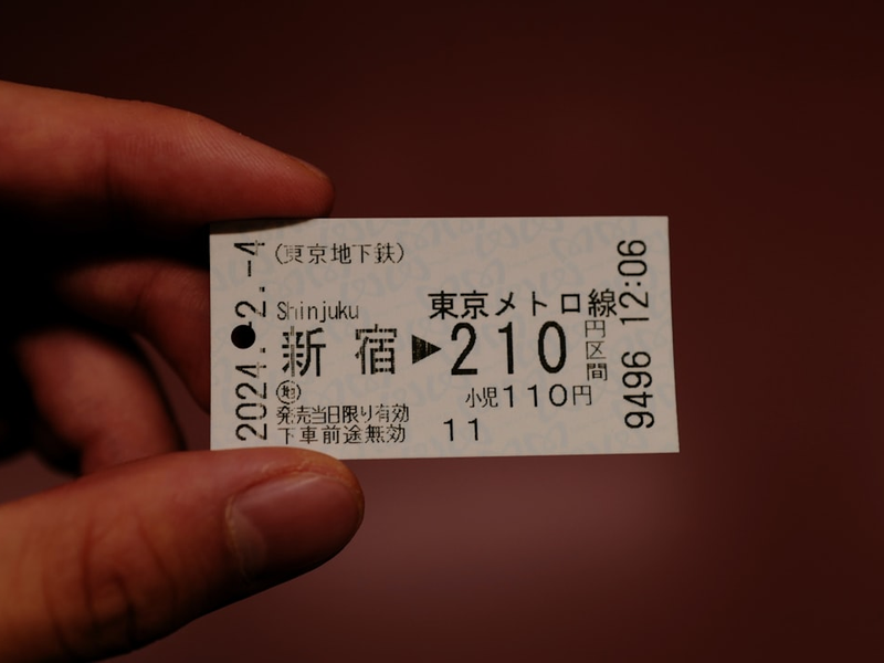a person holding a ticket in their hand