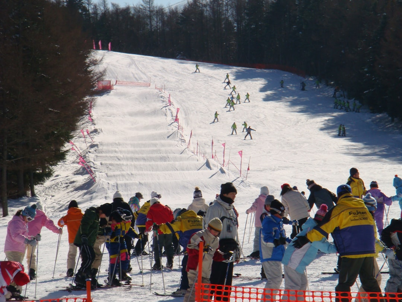 People are skiing on a snowy mountain slope.