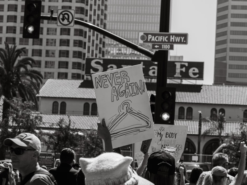 a crowd of people holding signs