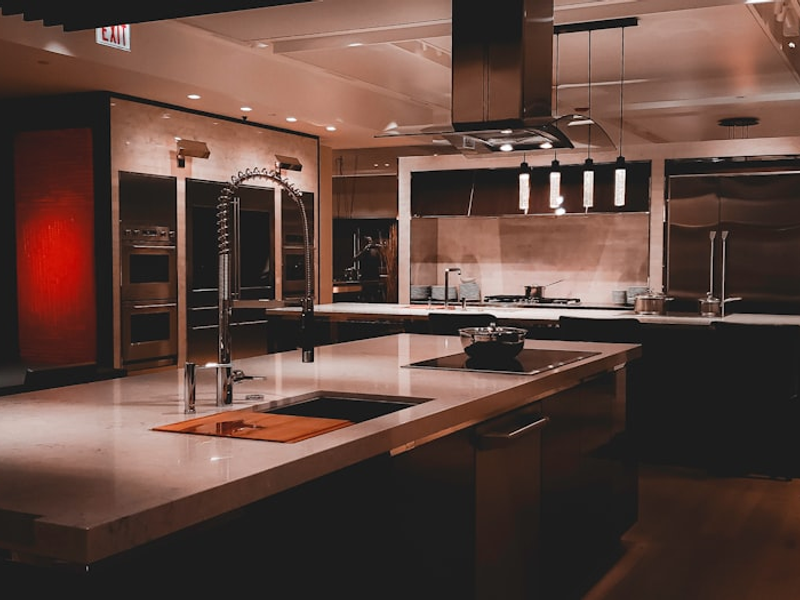A large kitchen with a center island and stainless steel appliances