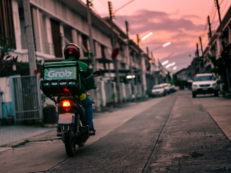 a person riding a motorcycle down a street