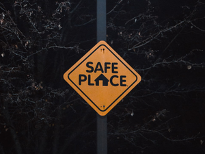A yellow sign that says safe place on it