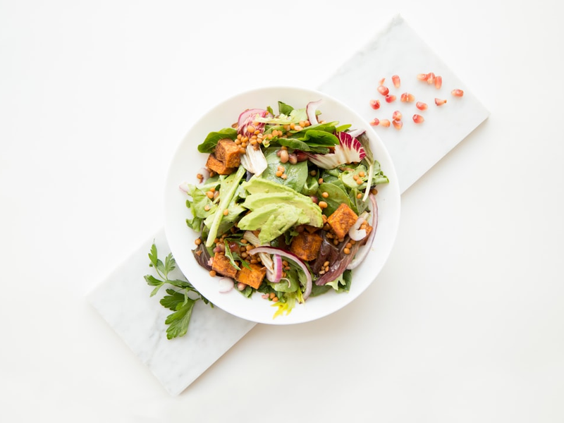 cooked food with sliced vegetables in white bowl
