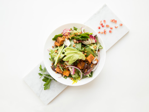 cooked food with sliced vegetables in white bowl