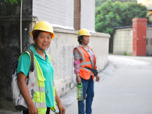 woman in green crew neck t-shirt wearing yellow hard hat