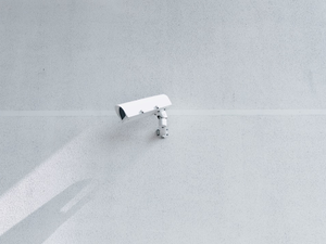 white box security camera on wall