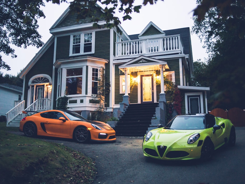 yellow lamborghini aventador parked in front of white and gray house