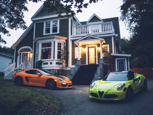 yellow lamborghini aventador parked in front of white and gray house