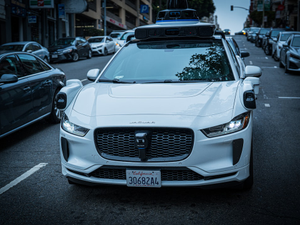 White self-driving car on a city street