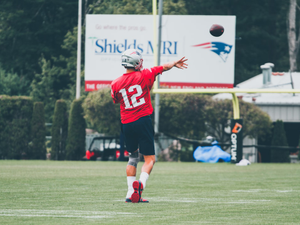 man in red and white football jersey holding white and red football