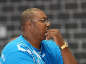 a man in a blue shirt with a watch on his left hand