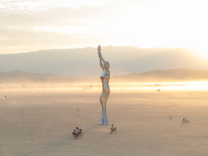 A statue of a woman in the middle of a desert