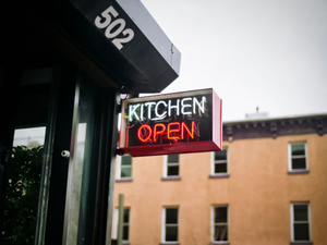white and red neon lighted kitchen open signage during daytime