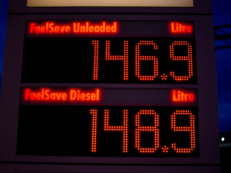 a gas station sign displays the time for gas prices