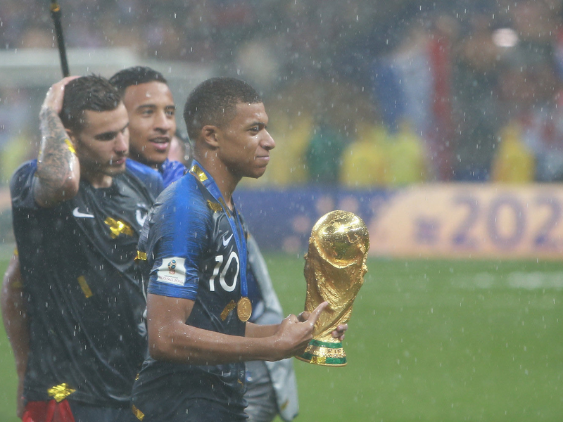 Kylian Mbappé with the 2018 Soccer World Cup trophy