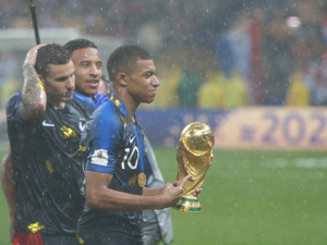Kylian Mbappé with the 2018 Soccer World Cup trophy