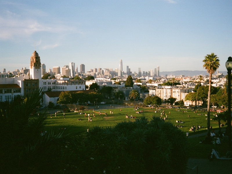 City skyline viewed over a park with people