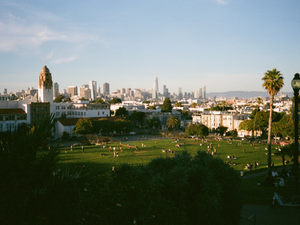 City skyline viewed over a park with people