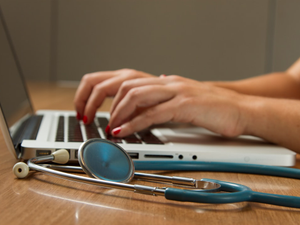 Stethoscope and Laptop Computer. Laptop computers and other kinds of mobile devices and communications technologies are of increasing importance in the delivery of health care. Photographer Daniel Sone  