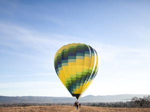 yellow and blue hot air balloon at the ground
