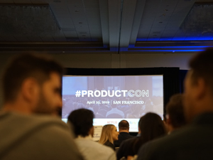 people in conference with projector screen in front