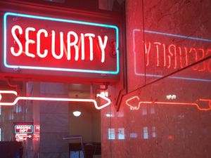 a red security sign and a blue security sign