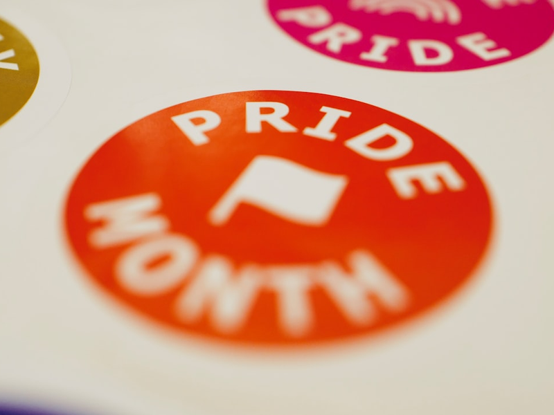 Pride month stickers with flags are displayed.