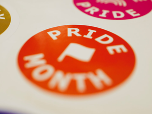 Pride month stickers with flags are displayed.