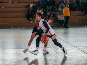 A couple of men playing a game of basketball